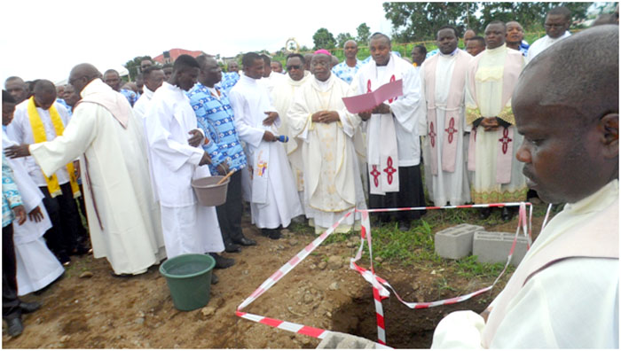 Bishop Agapitus Nfon cuts the ribbon, laying the foundation stone for the CMA National Secretariat