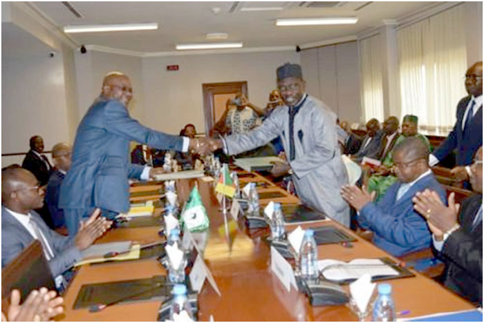 Minister of Economy Alamine Ousmane Mey exchanging document with official of AfDB