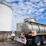 Fuel storage tank and tanker truck at a petroleum depot