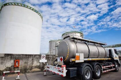 Fuel storage tank and tanker truck at a petroleum depot